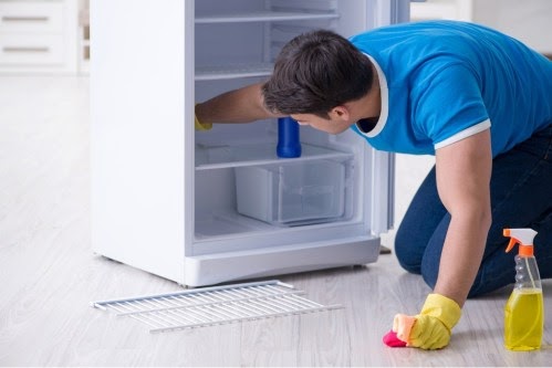 man-cleaning-fridge